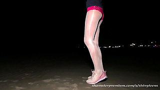 Anna in white shiny pantyhose on the night beach