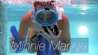 Seductive diver Minnie Manga sucks a suction cup dildo under the water