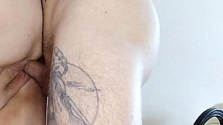 A girlfriend with a big ass stands doggy style and takes a dick in her pussy