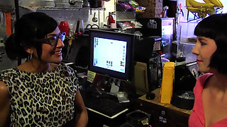 A young and sexy brunette seduced by a lesbian in a shop and dragged in the toilet for fuck