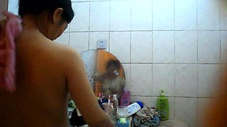 Voyeur spying on a busty mature Asian wife in the bathroom