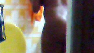 Hidden surveillance in the bathroom of an ebony woman with a nice body