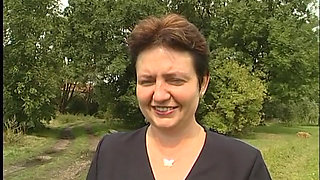 Lovely mature lady blows a guy's cock outdoors near the car