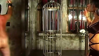 Brunette Dominatrix Teases Her Masked Caged Slave