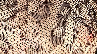 I'm Posing in a Black Fishnet Bodysuit and Heels, Pleasuring Myself with My Fingers.