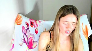 Masturbating blonde teen on couch with big toys