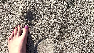 Comparing Size 16 Feet to Sand Prints at the Beach