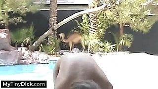 A cute blonde by the pool is sucking is small dick hard