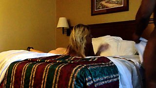 Slender blonde has a black guy plowing her pussy on the bed
